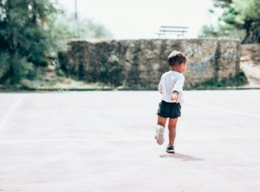 toddler running on gray concrete floor